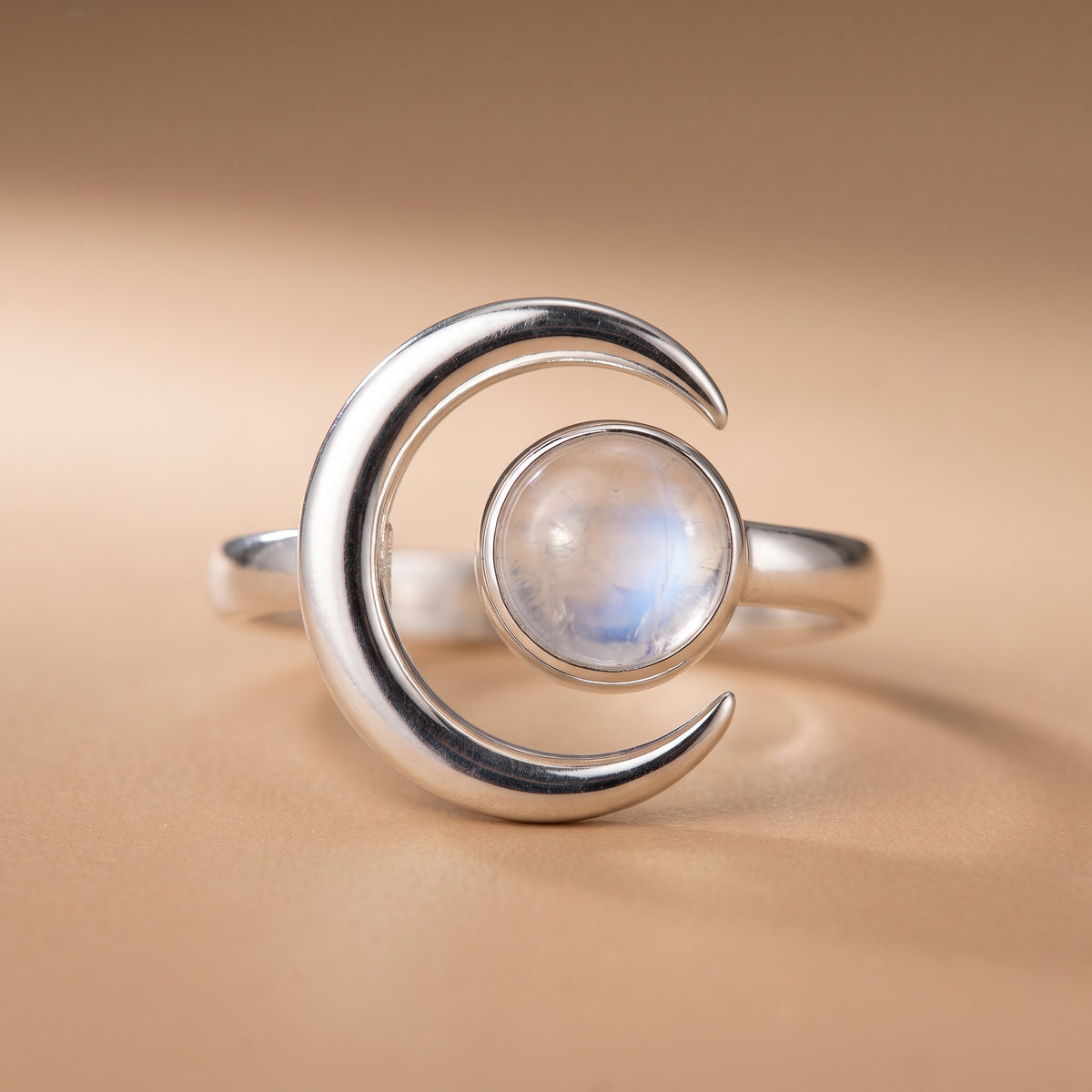 hero: A NEW photorealistic photograph composed from scratch, featuring a premium product photograph of a vintage-style ring. The ring is placed on a seamless matte warm beige studio surface that naturally flows into a softly graduated matching background. The atmosphere is quiet, neutral, and minimal. The product is viewed straight on at eye level, matching its natural orientation, centered horizontally, and positioned slightly below the vertical center. The complete ring is visible, filling approximately…