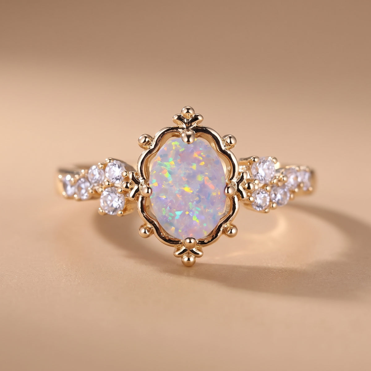 hero: A NEW photorealistic photograph composed from scratch. The product, a ring, rests on a seamless matte warm beige studio surface that flows naturally into a matching softly graduated background. The atmosphere is quiet, neutral, and minimal. The camera is positioned at eye-level, capturing the product in a clean, straight-on view, preserving its natural orientation. A large, soft, diffused light source emanates from camera left, providing gentle frontal fill. This lighting creates controlled highlight…